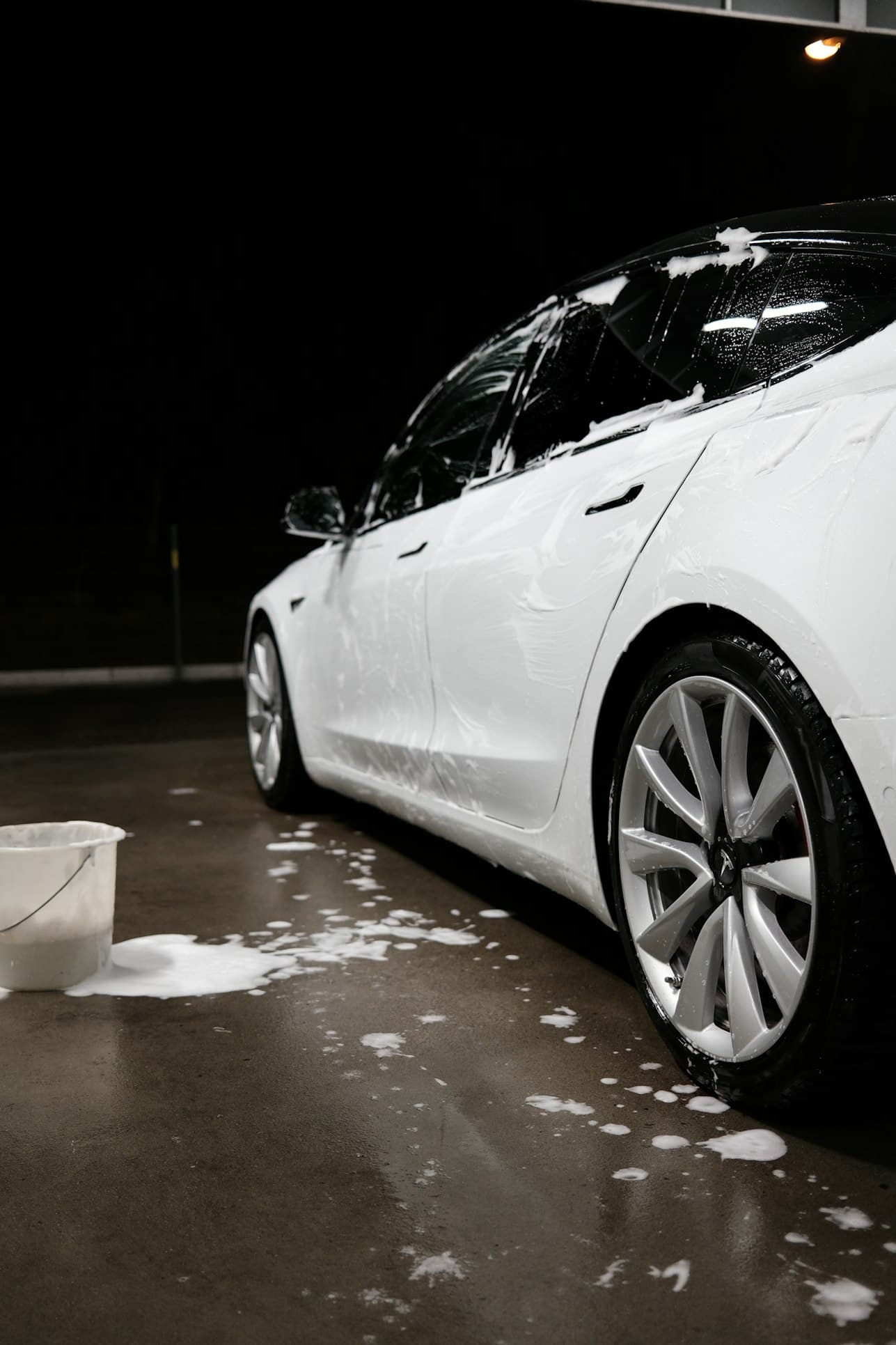 foam wash on a white vehicle at night