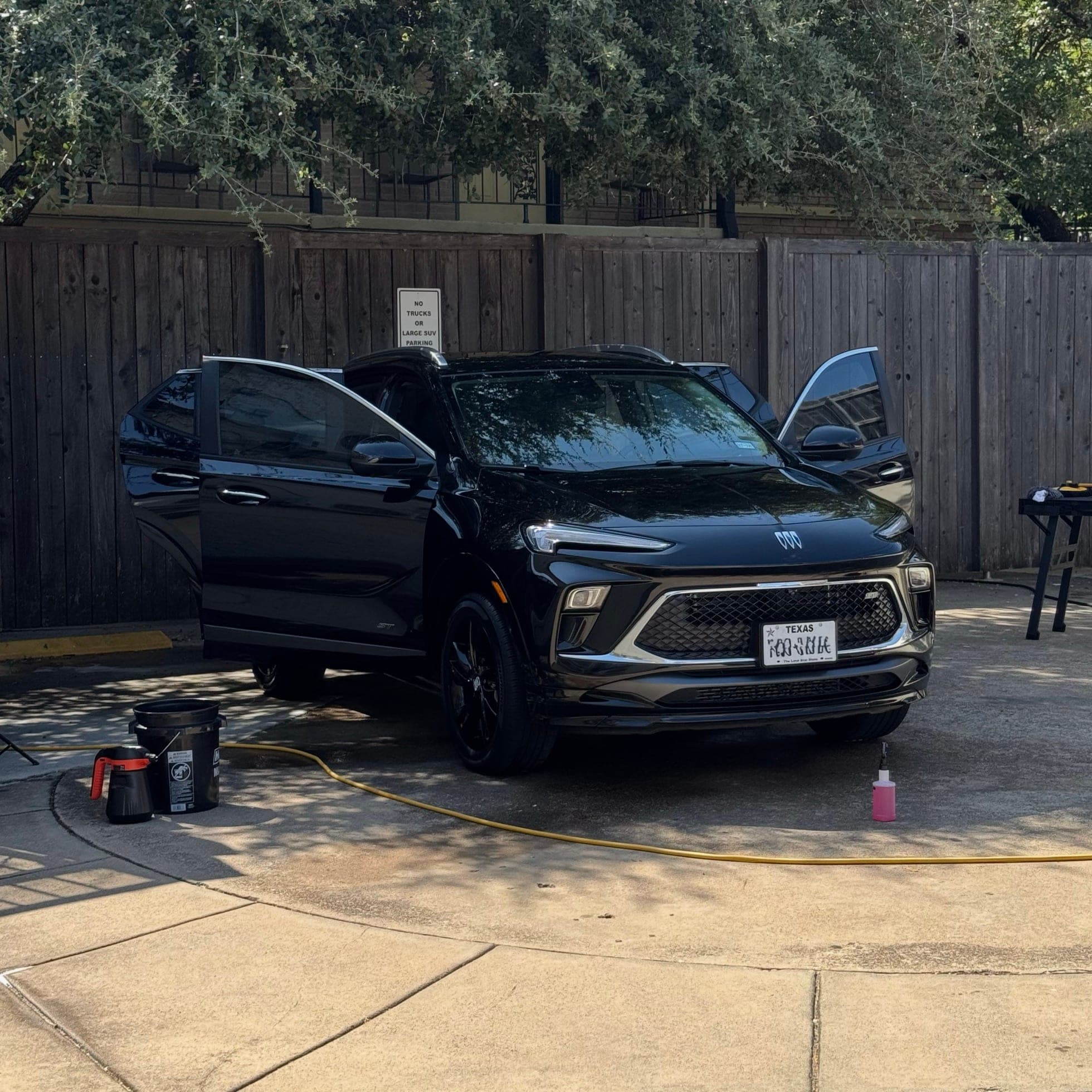 black suv with doors open during a mobile detail